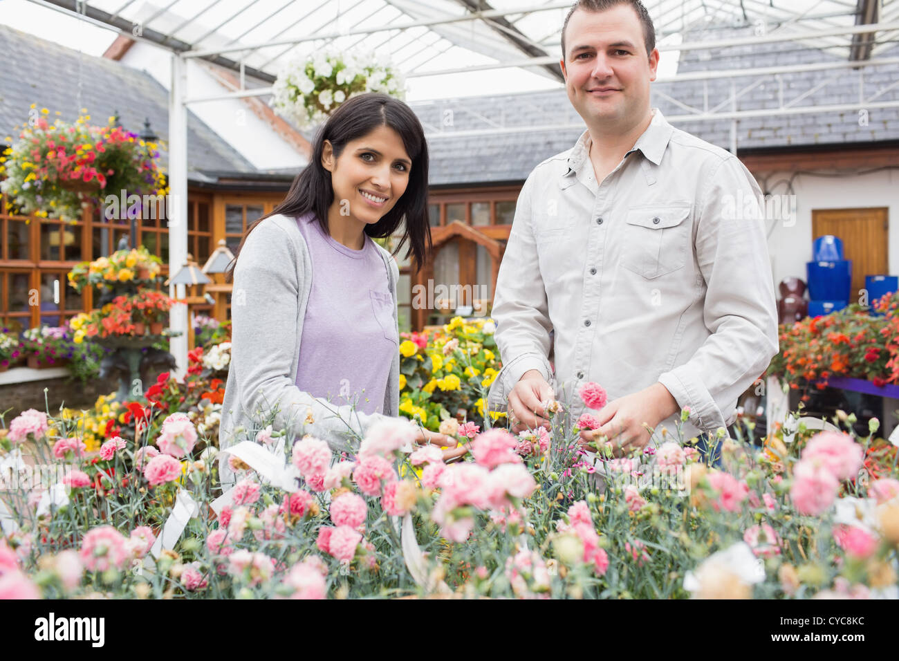 Happy couple choosing plants Stock Photo - Alamy