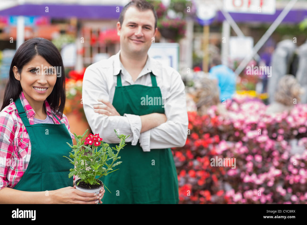 Two smiling garden center employees Stock Photo - Alamy