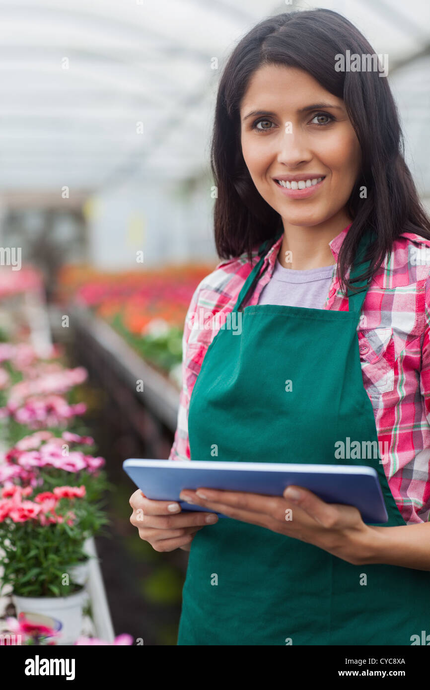 Woman doing inventory in greenhouse Stock Photo