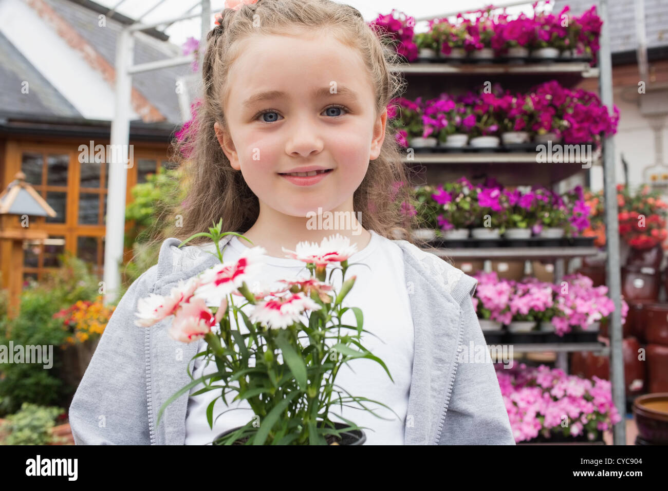 Child holding potted plant Stock Photo - Alamy