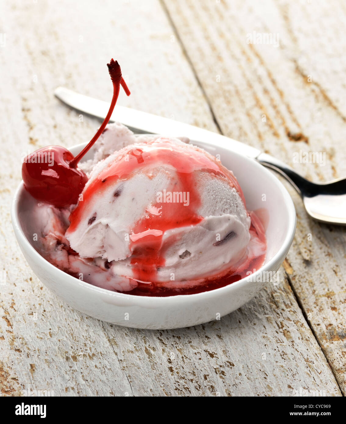 Vanilla And Cherry Ice Cream On A Wooden Table Stock Photo