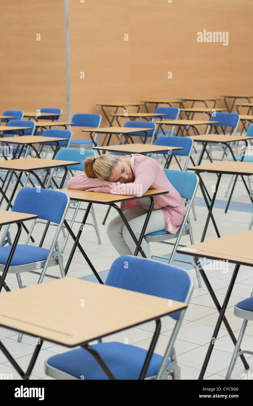 Student napping in exam hall Stock Photo