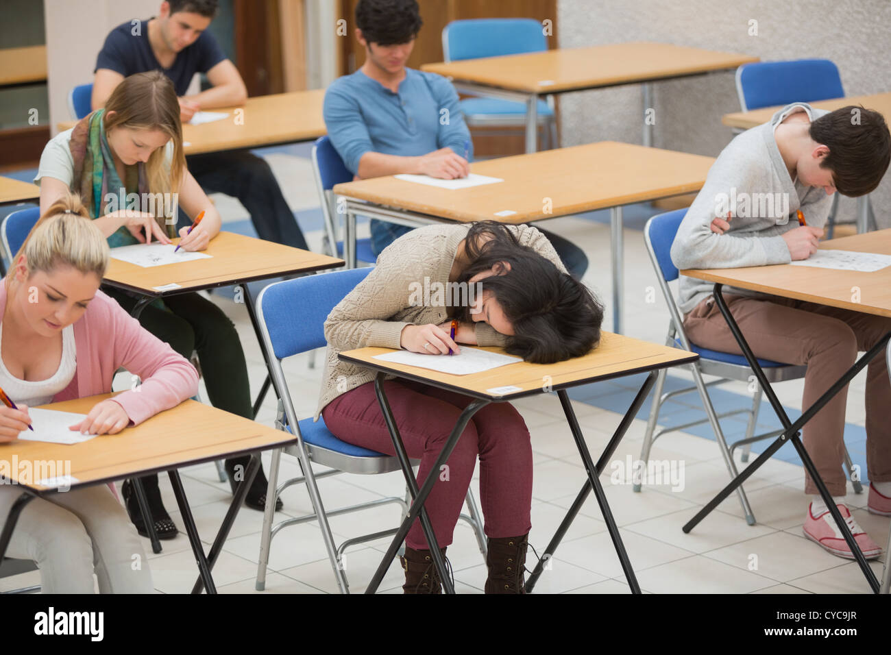 Girl sleeping during exam Stock Photo Alamy