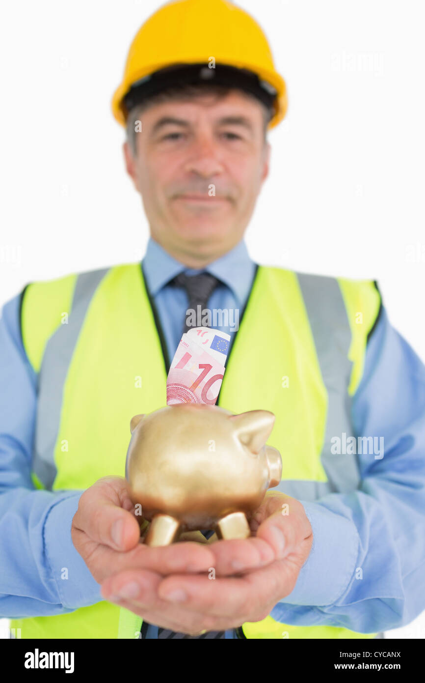 Man holding piggy bank with money Stock Photo - Alamy