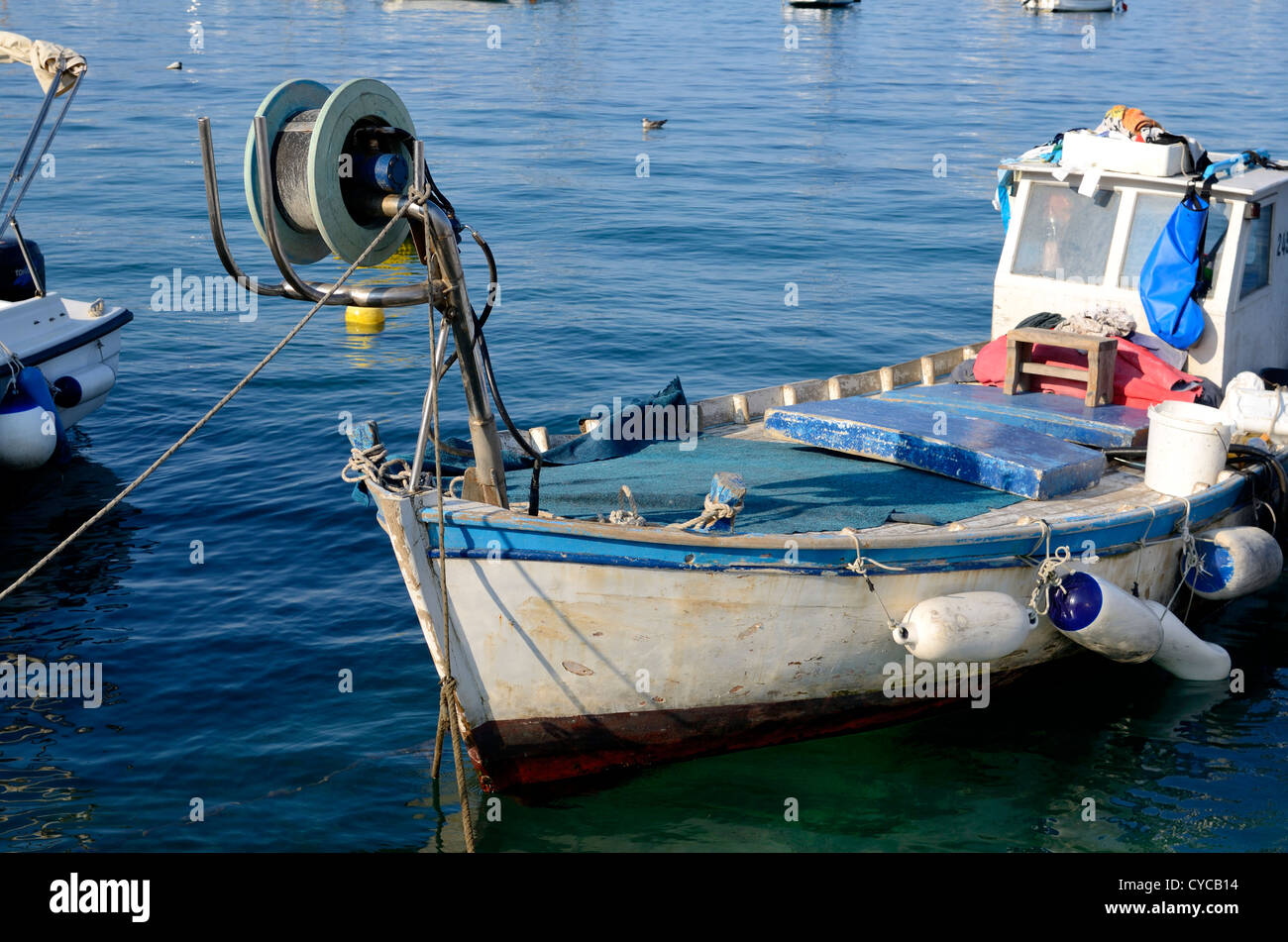 A wooden boat on a dark blue sea during summer Stock Photo - Alamy