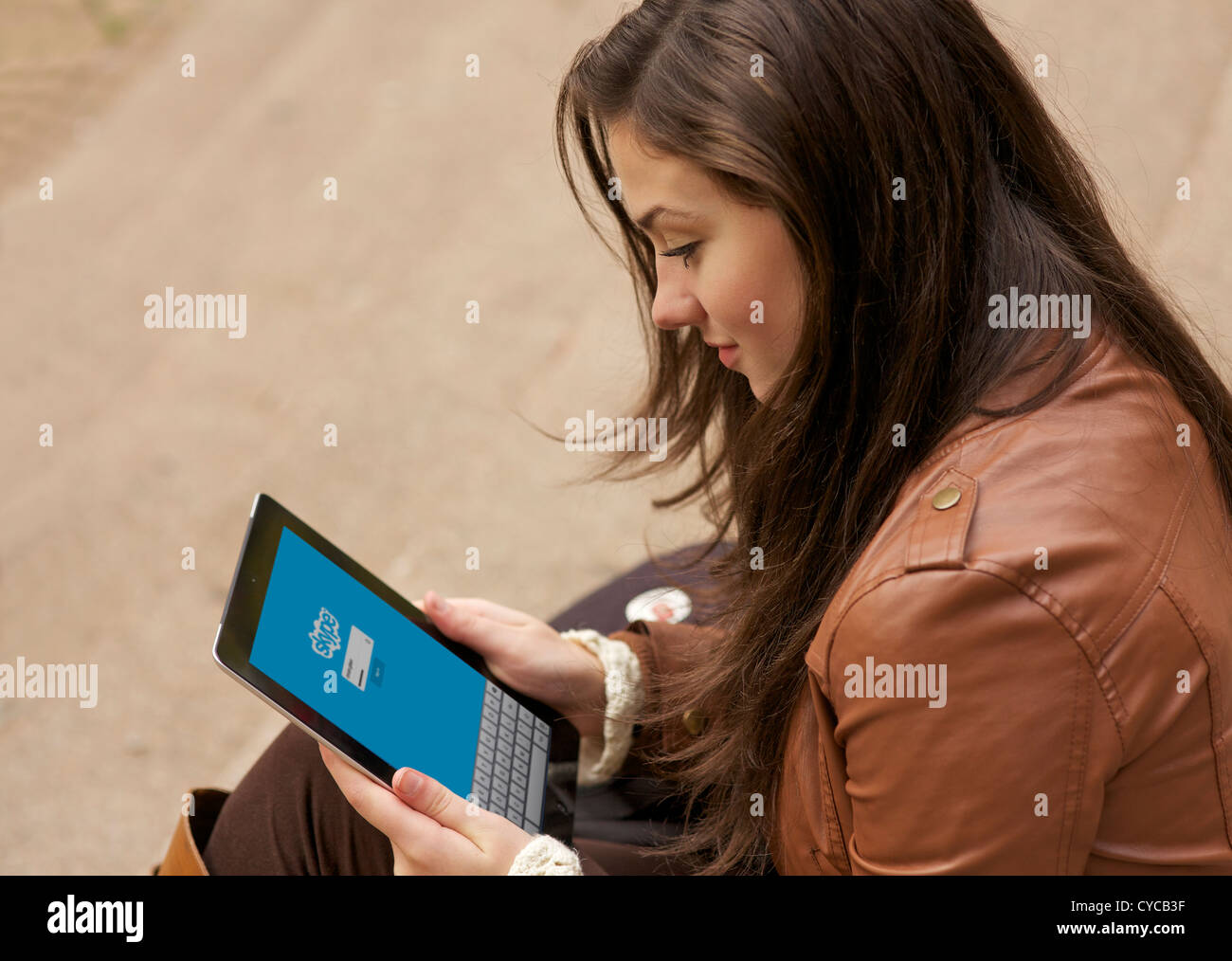 Beautiful young woman using Skype on her iPad Stock Photo