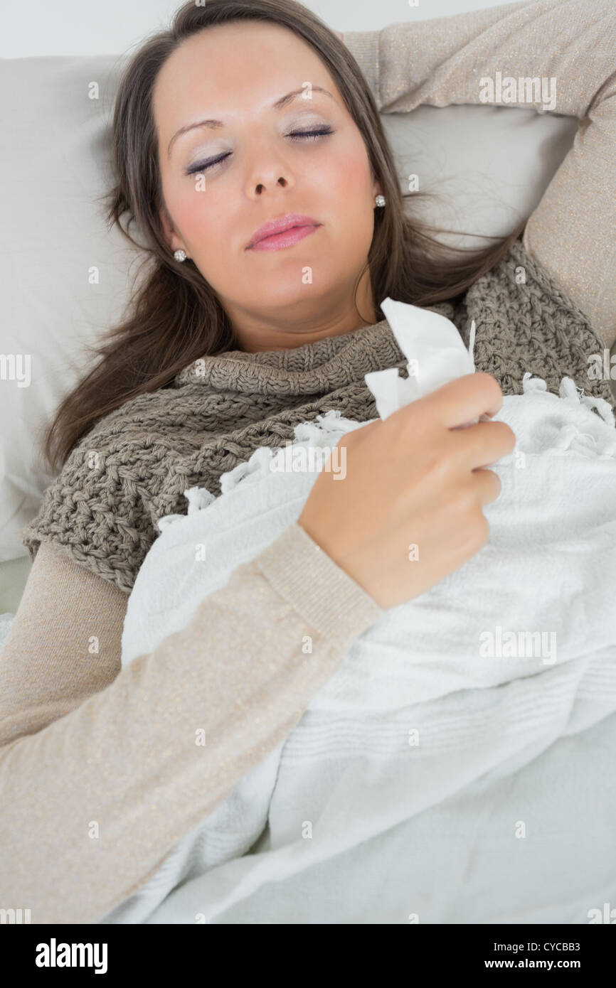 Sleeping woman lying on sofa with a cold Stock Photo Alamy