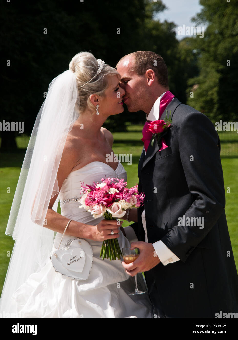 A bride and groom share a loving kiss on their wedding day Stock Photo ...
