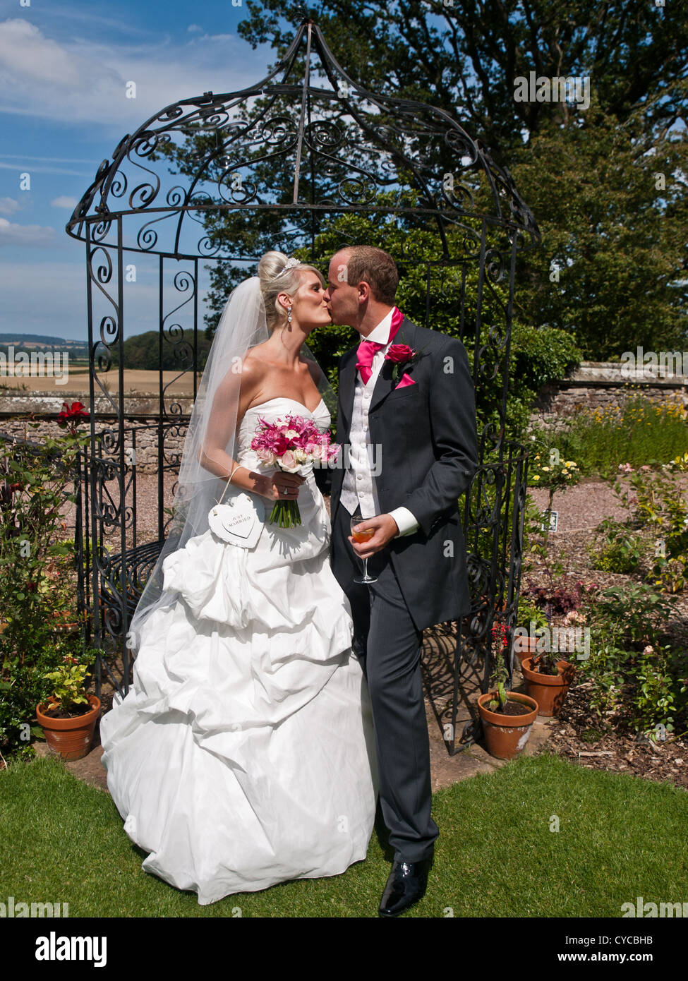 A bride and groom share a loving kiss on their wedding day Stock Photo ...