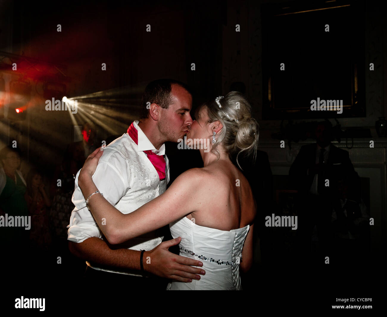 A bride and groom kiss romantically during the first dance on their wedding day. Stock Photo