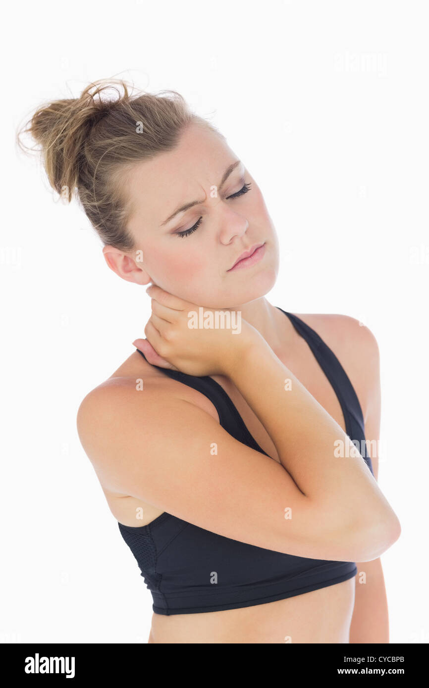 Woman holding hand to stiff neck Stock Photo