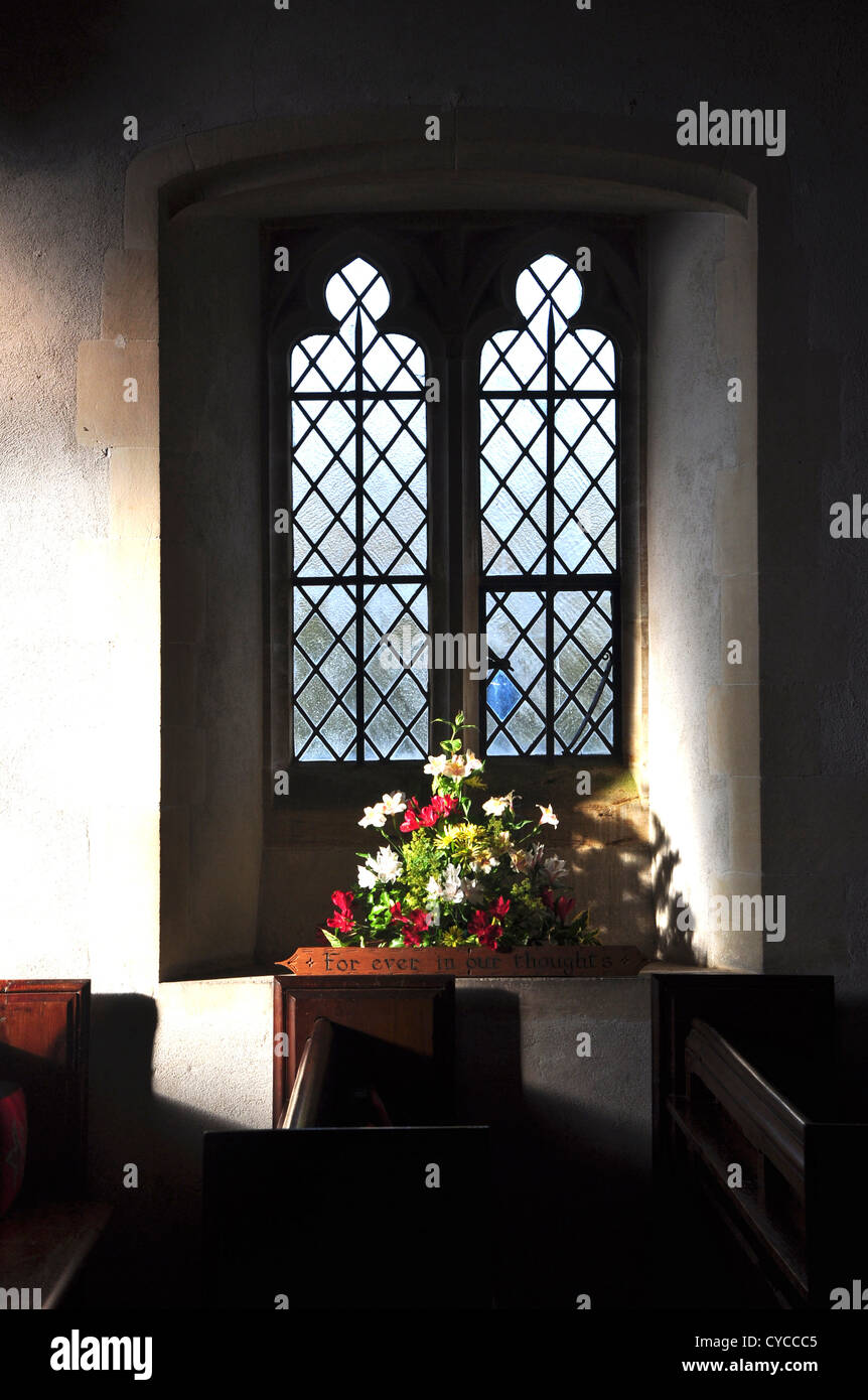 Flowers displayed in a church window UK Stock Photo