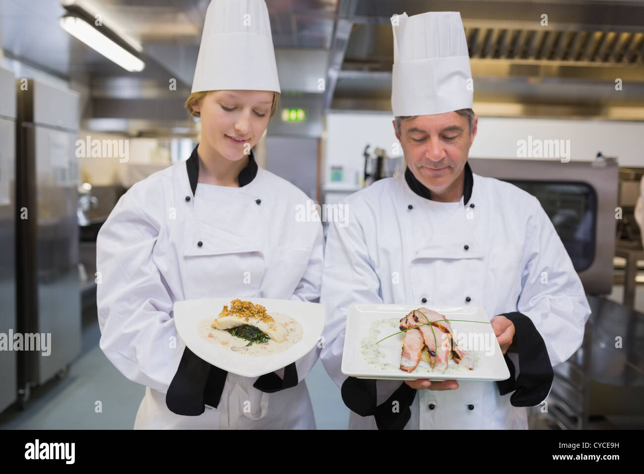 Chef's comparing chicken dishes Stock Photo - Alamy