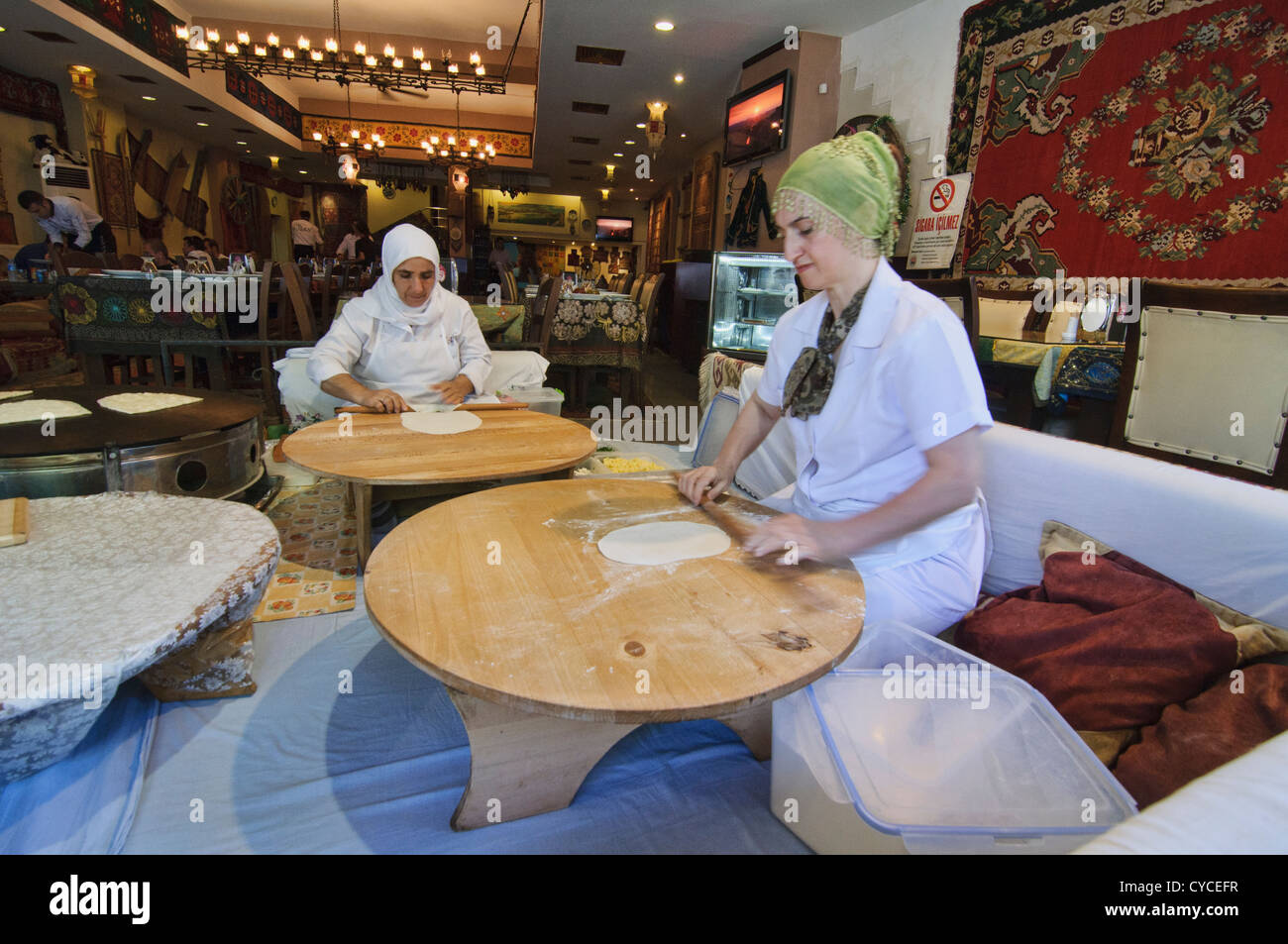 rolling dough to make Turkish pide in Istanbul, Turkey Stock Photo
