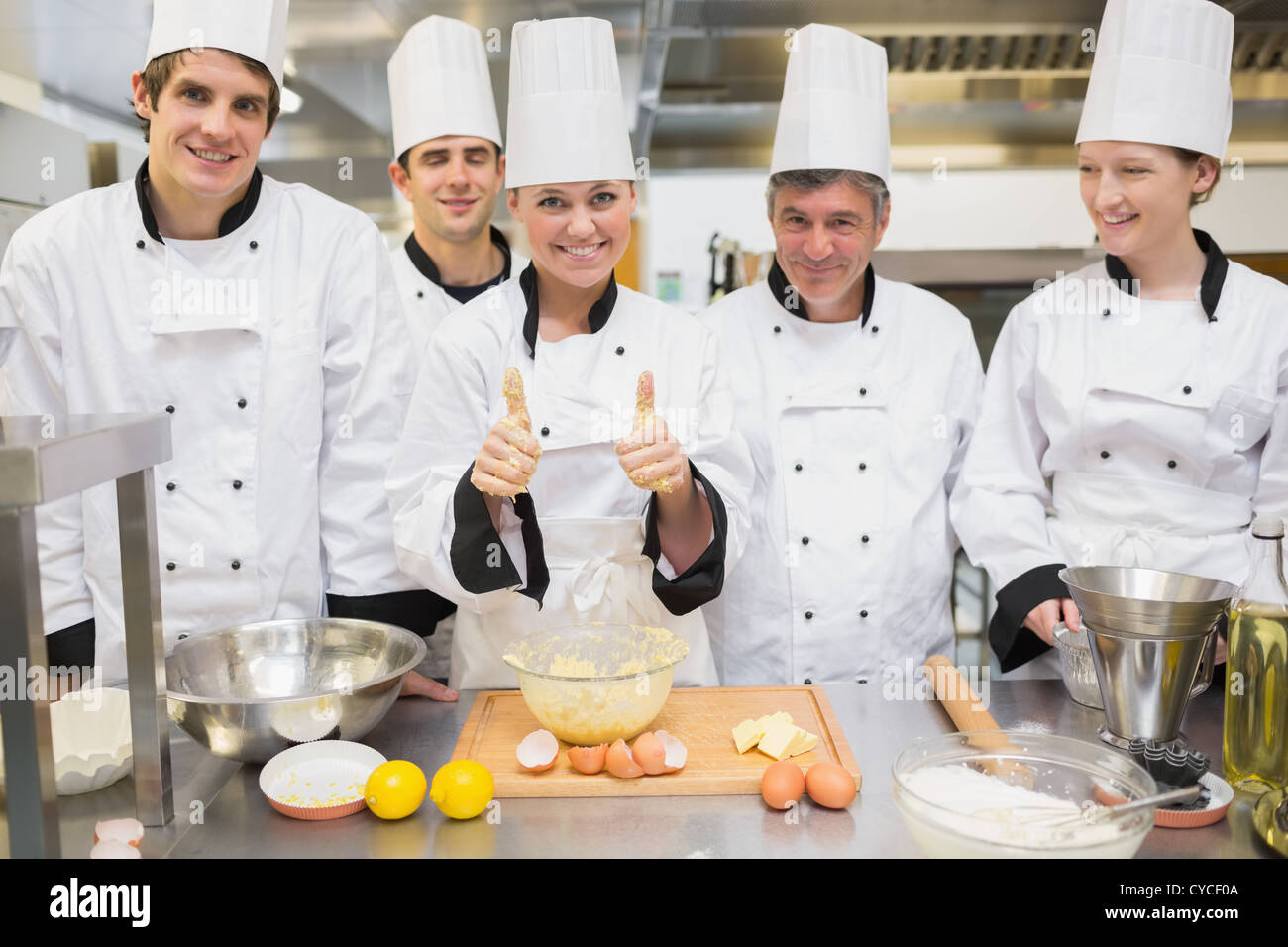 Culinary class with pastry teacher giving thumbs up Stock Photo Alamy