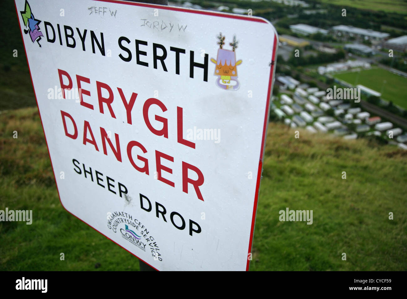 Sheer Drop warning sign changed to 'Sheep Drop' on the summit of Conwy Mountain, North Wales. Stock Photo