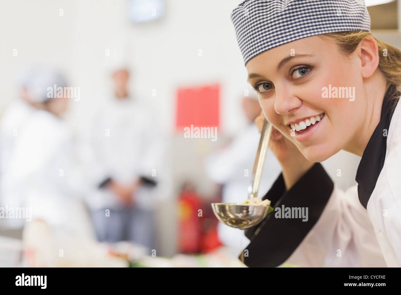 Smiling chef about to taste soup Stock Photo