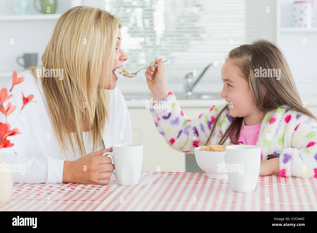 girl-feeding-her-mother-stock-photo-alamy