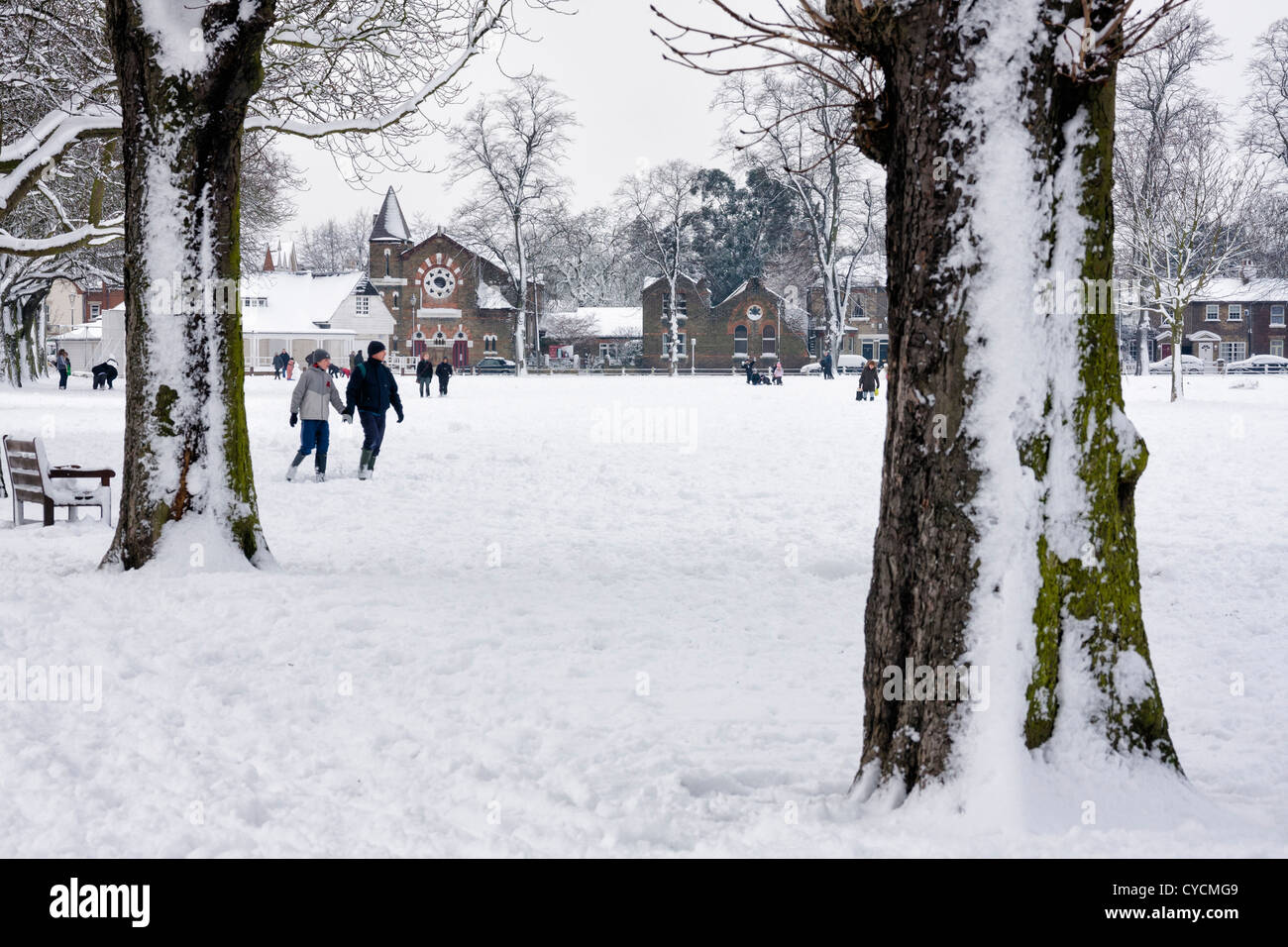 A view of the cricket pavilion, church and snow covered trees on Twickenham Green Stock Photo