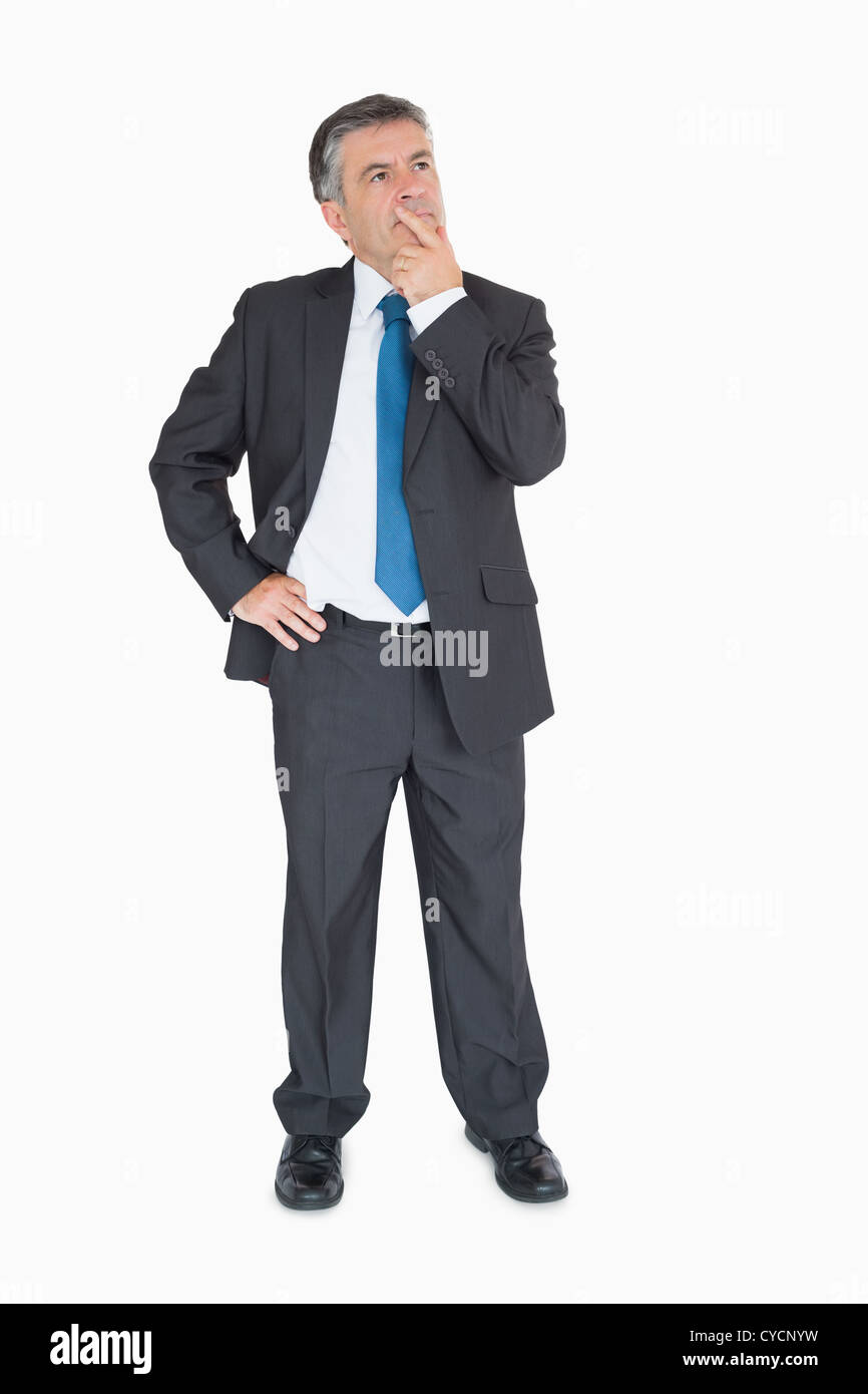 Businessman thinking with one hand on hip Stock Photo