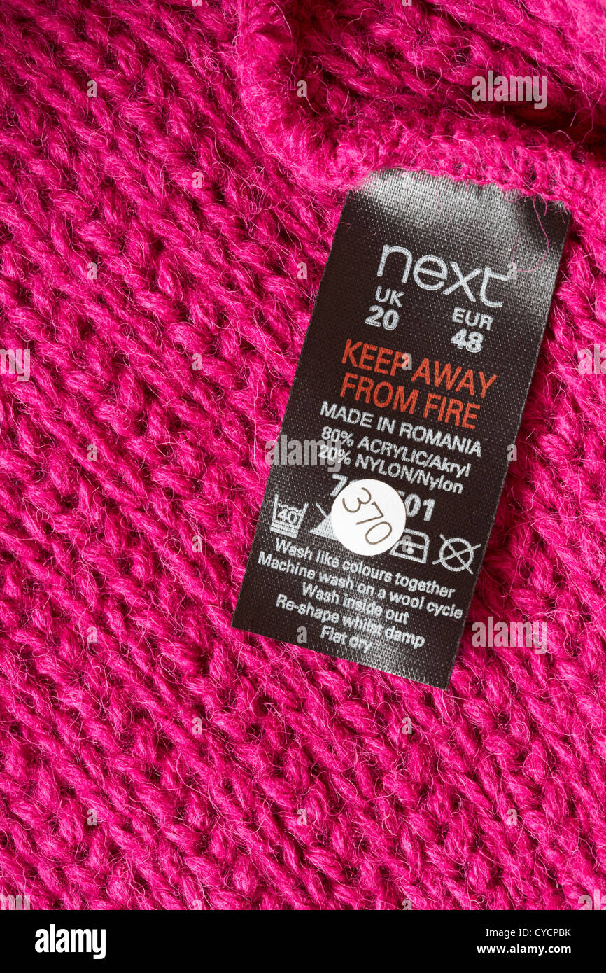 Next label in pink jumper made in Romania  - sold in the UK United Kingdom, Great Britain - care washing symbols and instructions Stock Photo