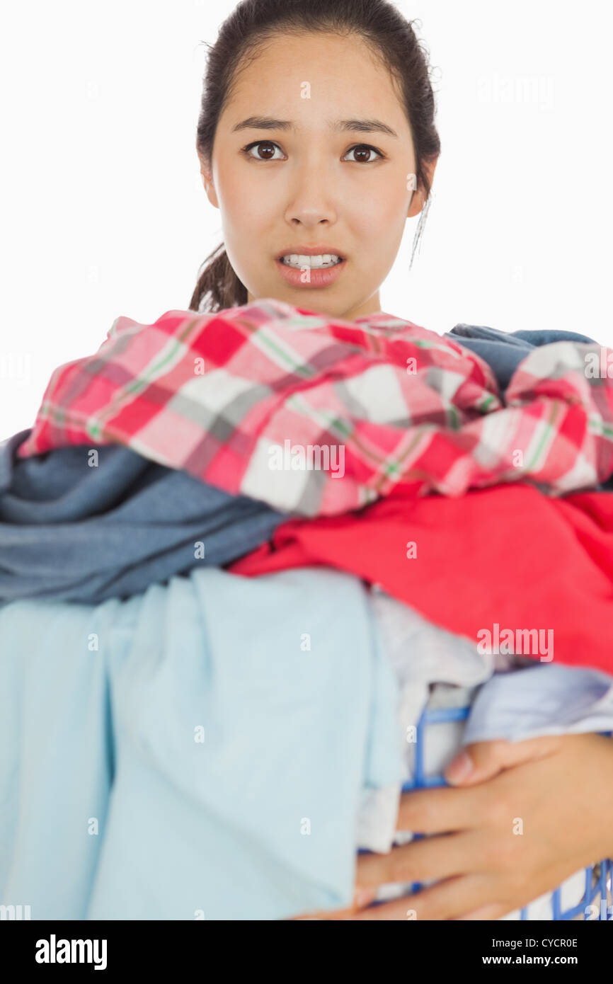 Woman overwhelmed with amount of dirty laundry Stock Photo