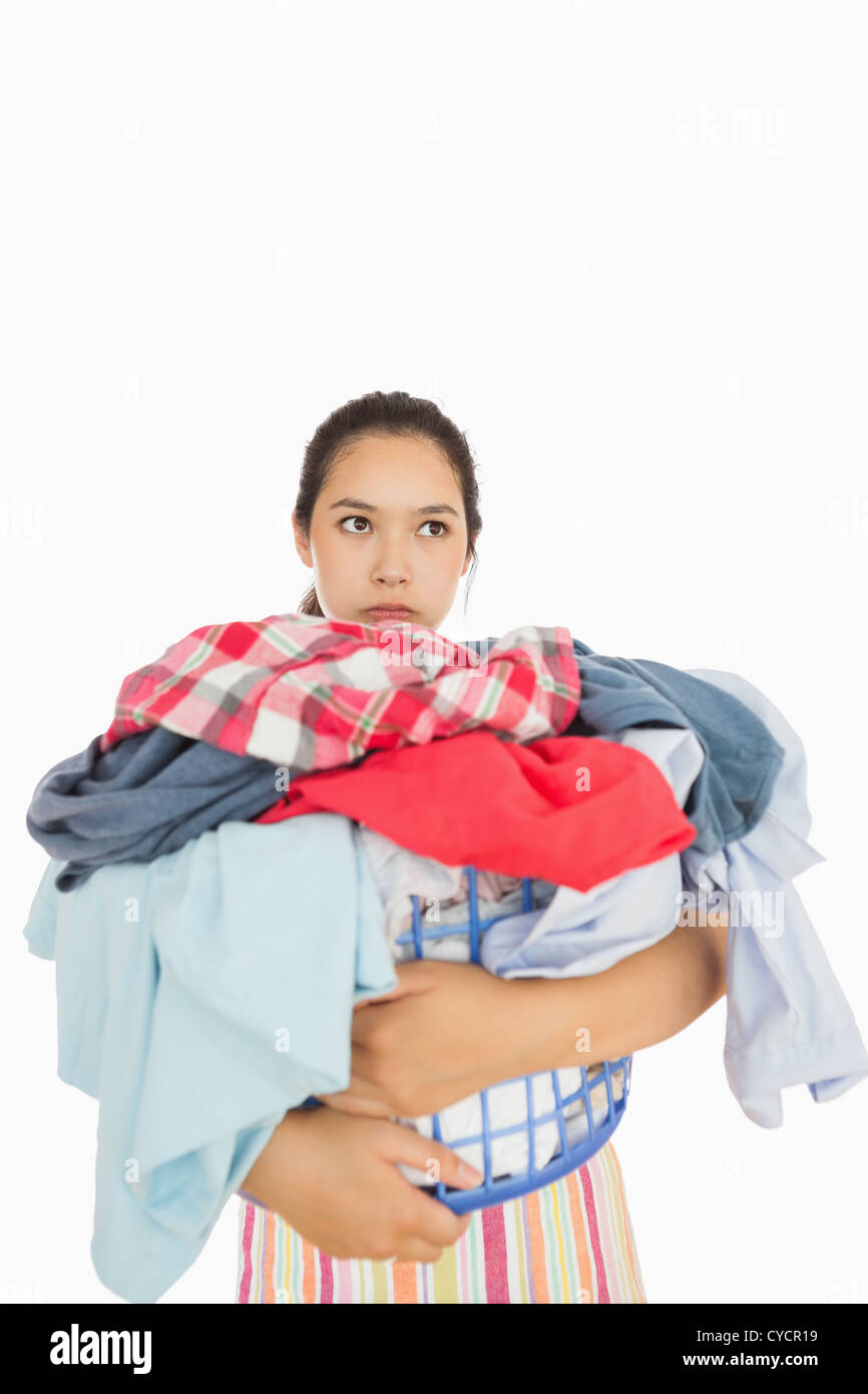 Exasperated woman holding laundry basket Stock Photo