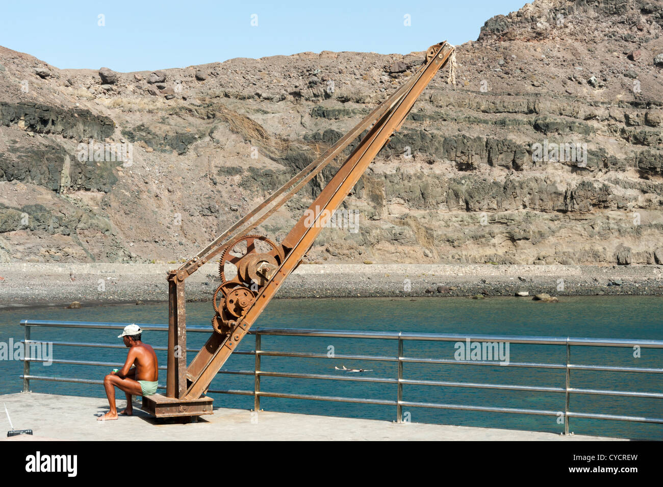 An old crane on the harbour at Puerto de las Nieves Gran Canaria Canary Islands Spain Stock Photo