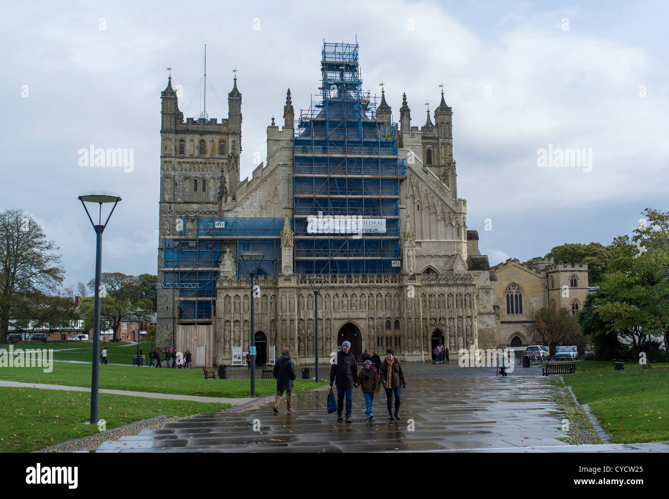 October 31st 2012. Exeter Cathedral, Exeter, Devon, England on a rainy day with scaffolding, shoppers and pedestrians. Stock Photo