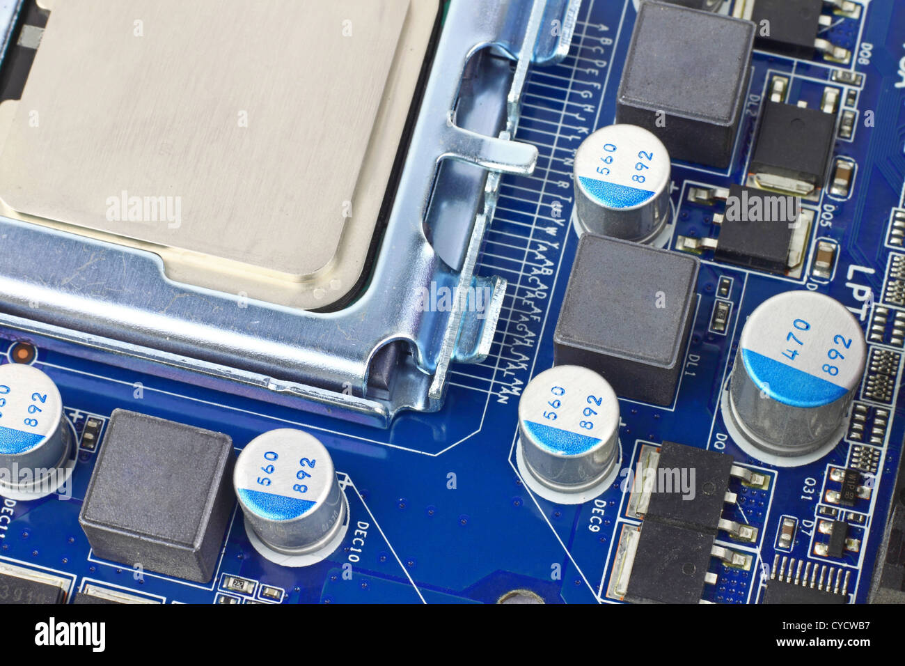 Digital hardware closeup. Microchips and condensers assembly on the circuit board macro Stock Photo