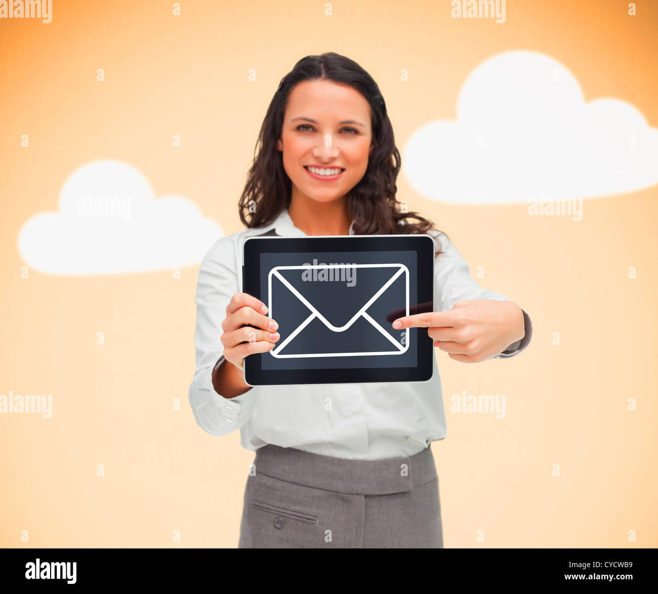 Woman standing holding a tablet pc with a message symbol Stock Photo