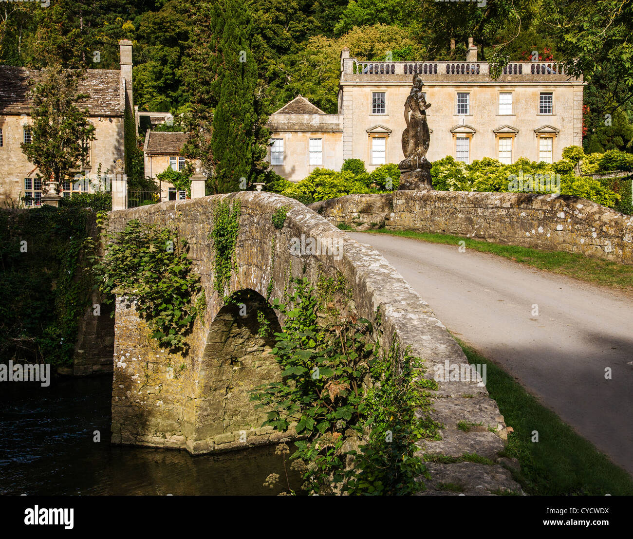 Bridge with statue of Britannia over the River Frome at Iford Manor in Wiltshire UK Stock Photo