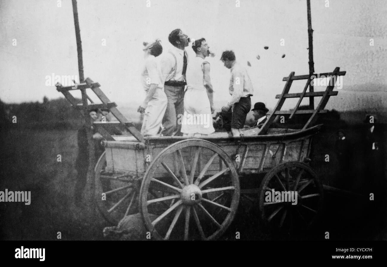 Apple Bobbing English Village fete apple eating competition. 1900s Stock Photo Alamy