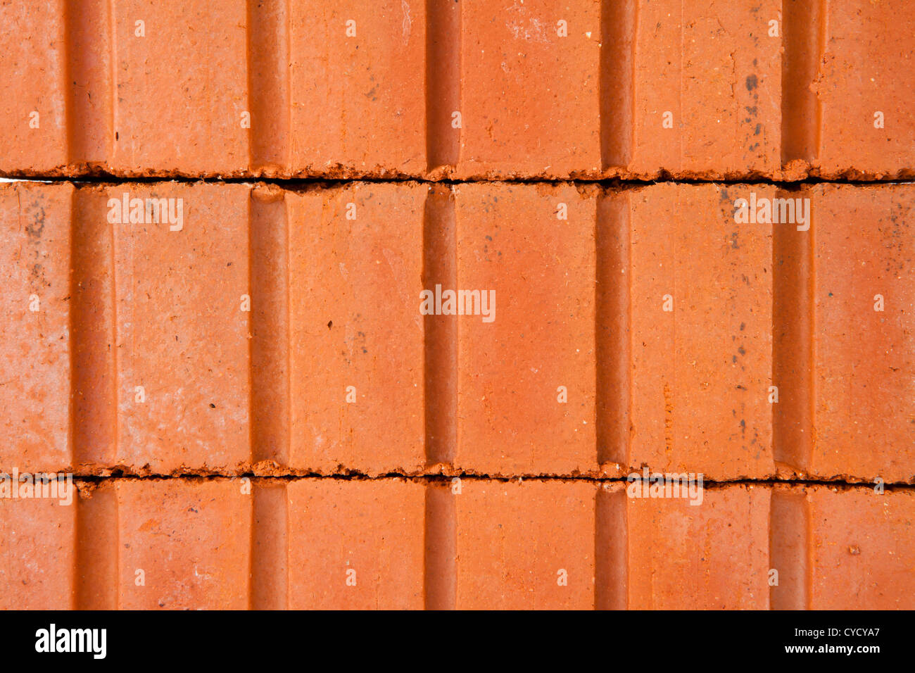 Stack of clay bricks building a wall Stock Photo
