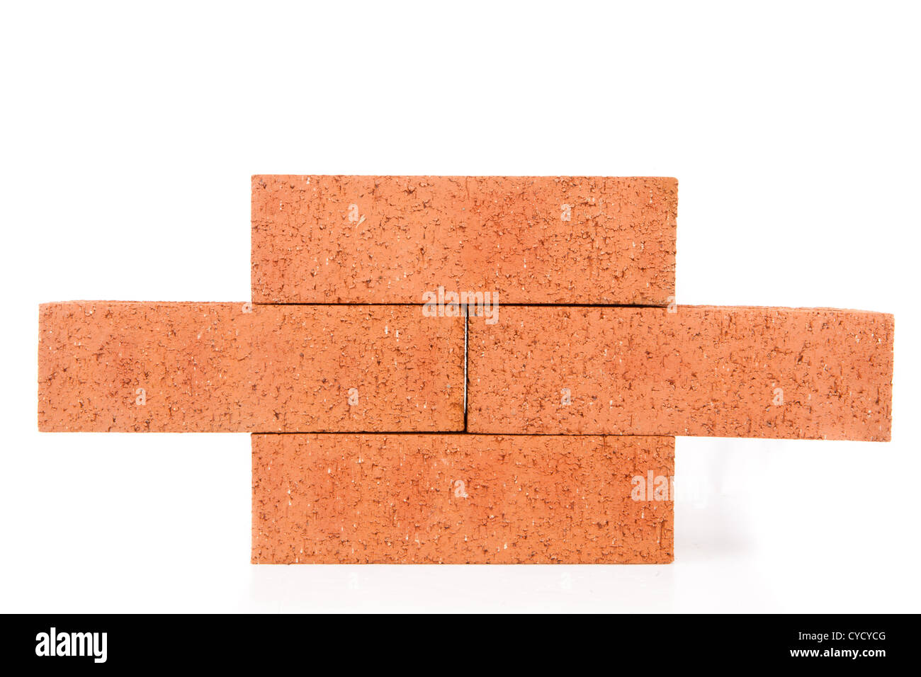Four clay bricks building a wall Stock Photo