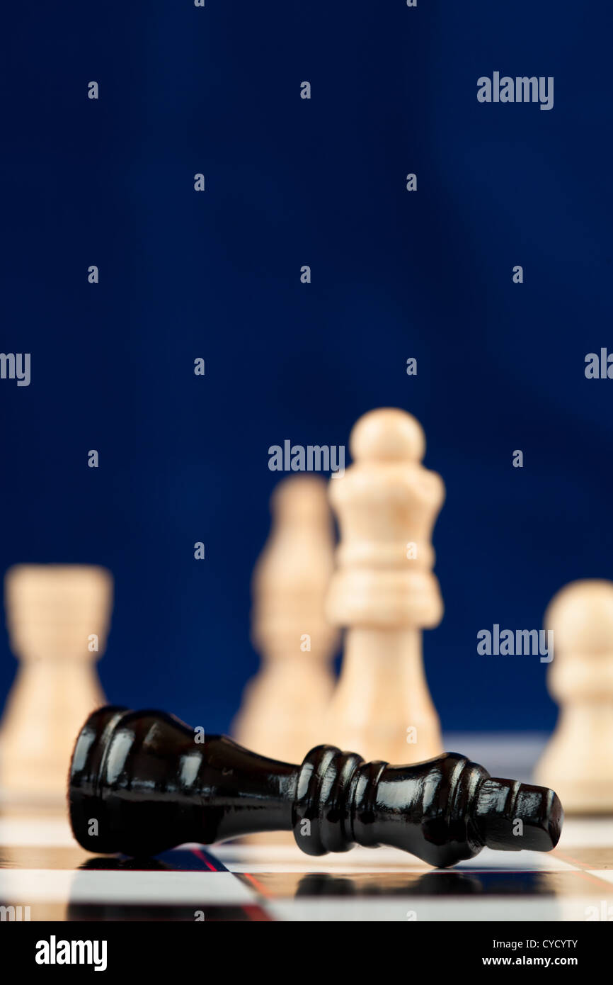 Black chess piece lying Stock Photo