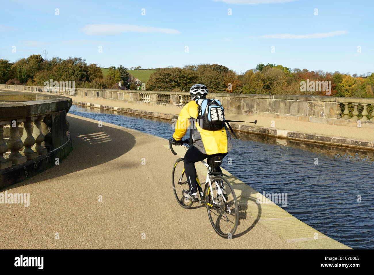 A cyclist on the Lancaster Canal tow path crosses The Lune Aqueduct in Lancaster UK Stock Photo
