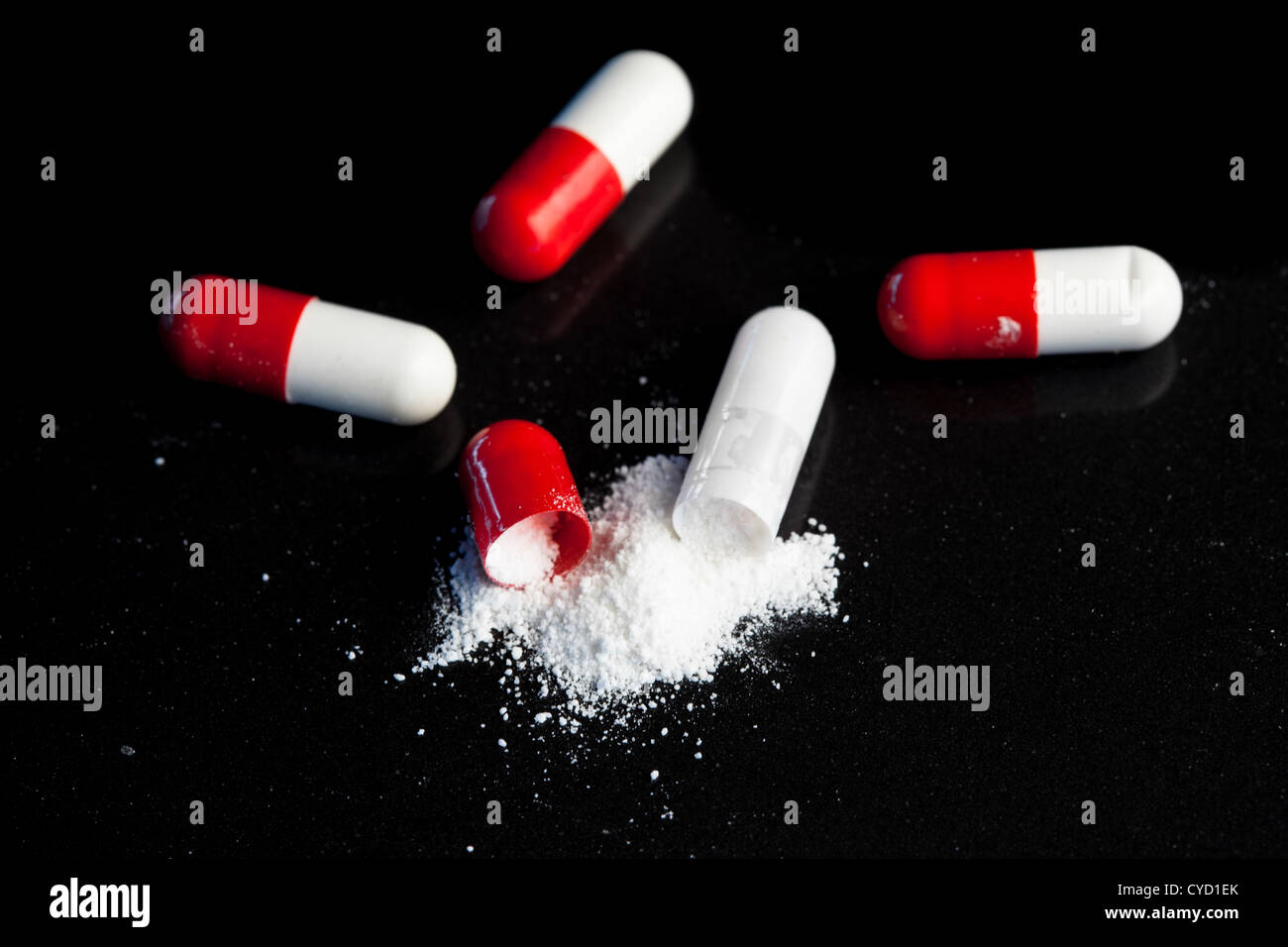 Red and white pills broken Stock Photo