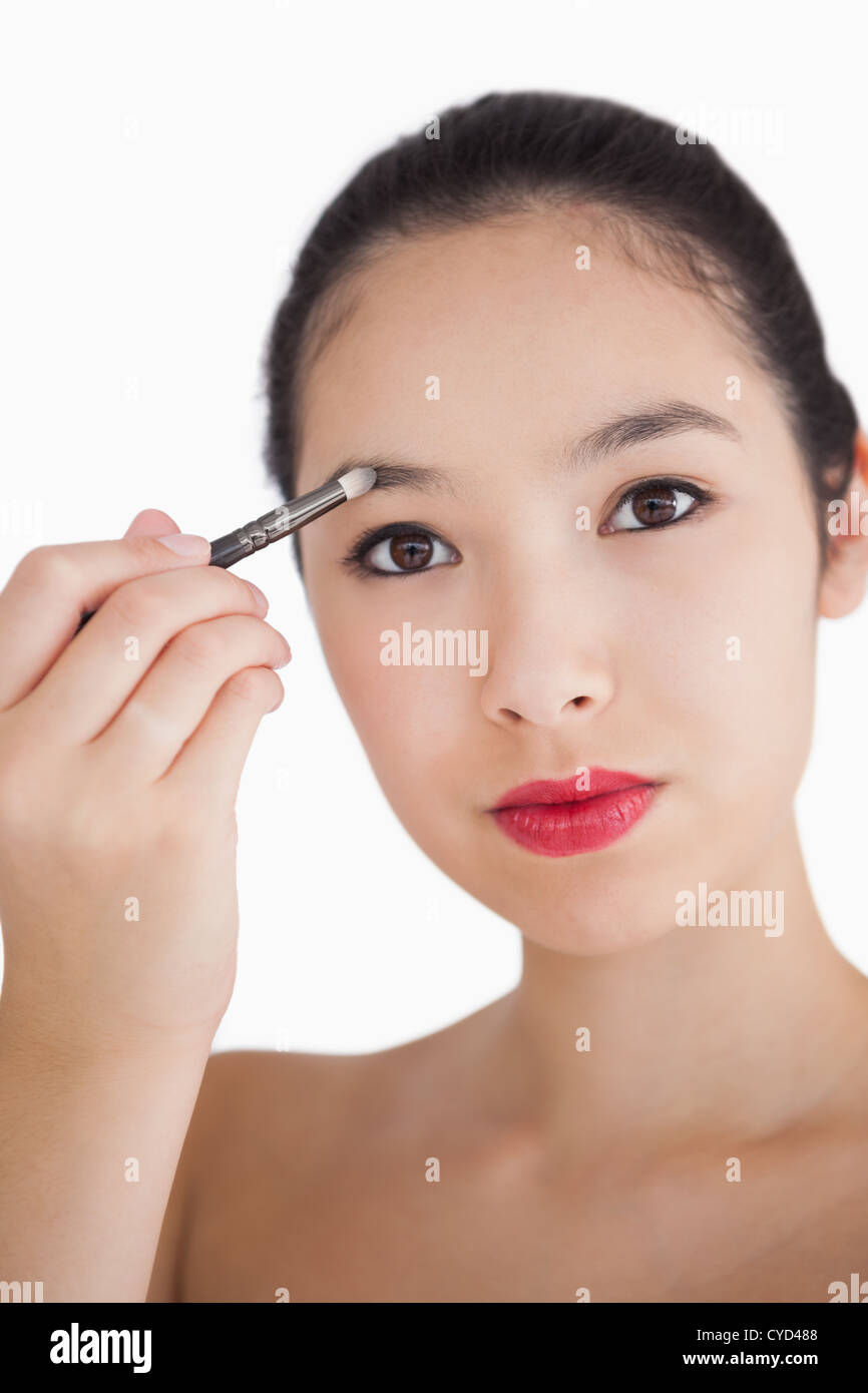 Woman filling in eyebrows Stock Photo