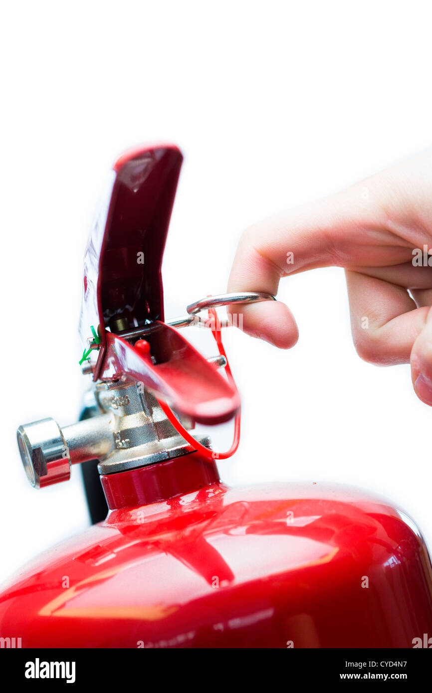 Hand pulling safety pin from fire extinguisher Stock Photo - Alamy