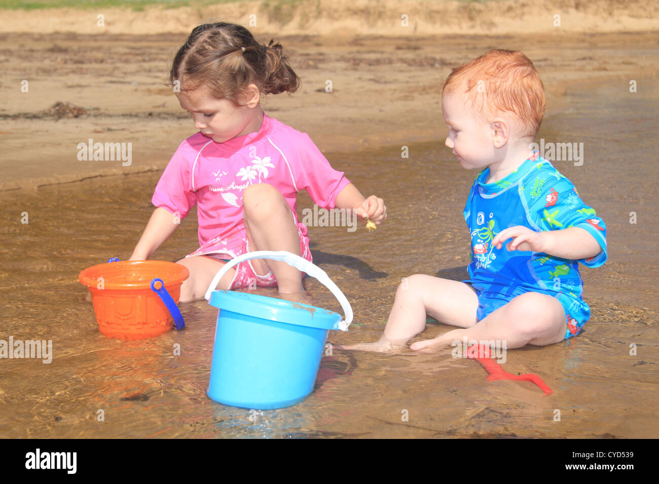 Children playing with bucket and spades hires stock photography and