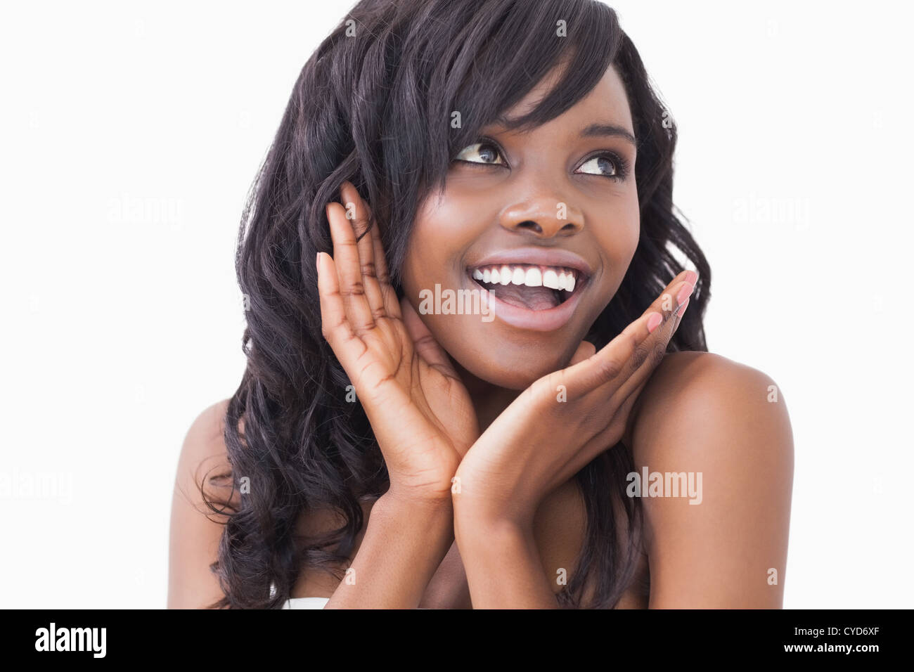 Woman with hands at cheek smiling Stock Photo