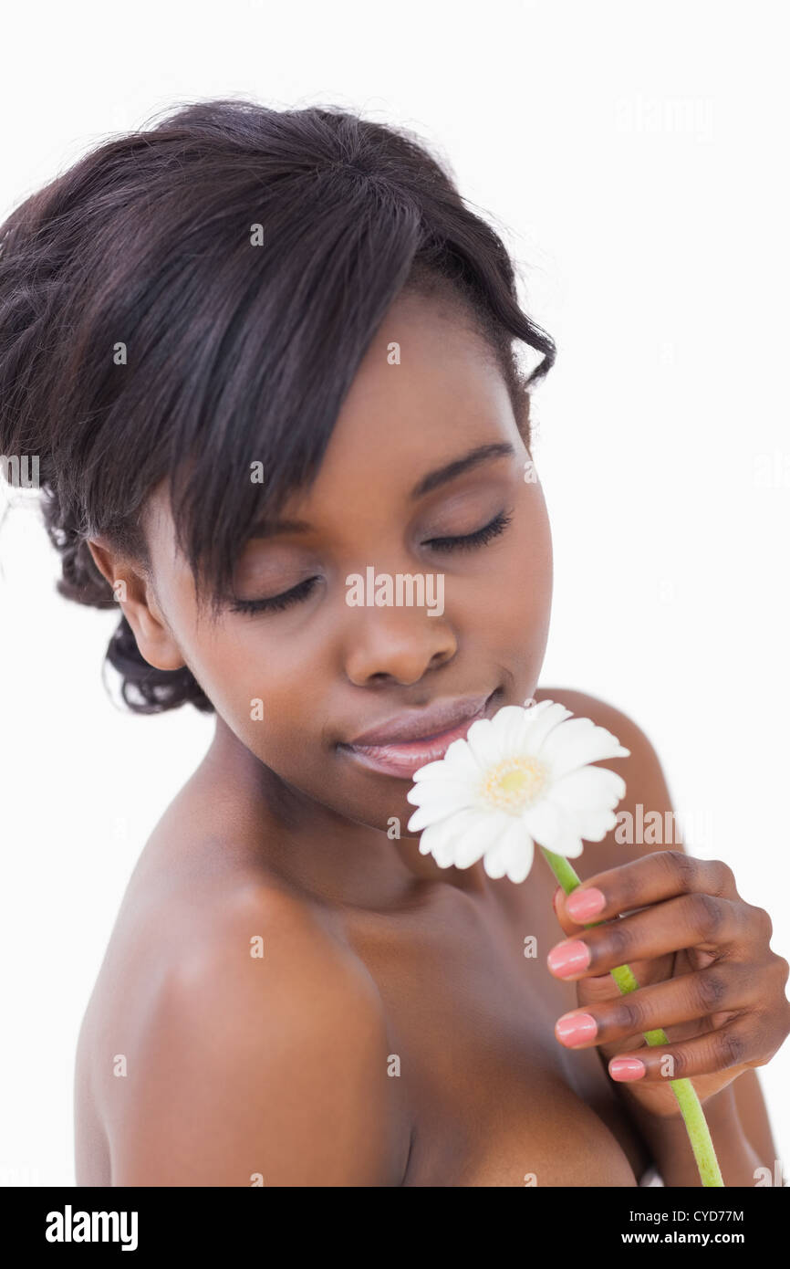 Woman smelling at a flower with eyes closed Stock Photo - Alamy