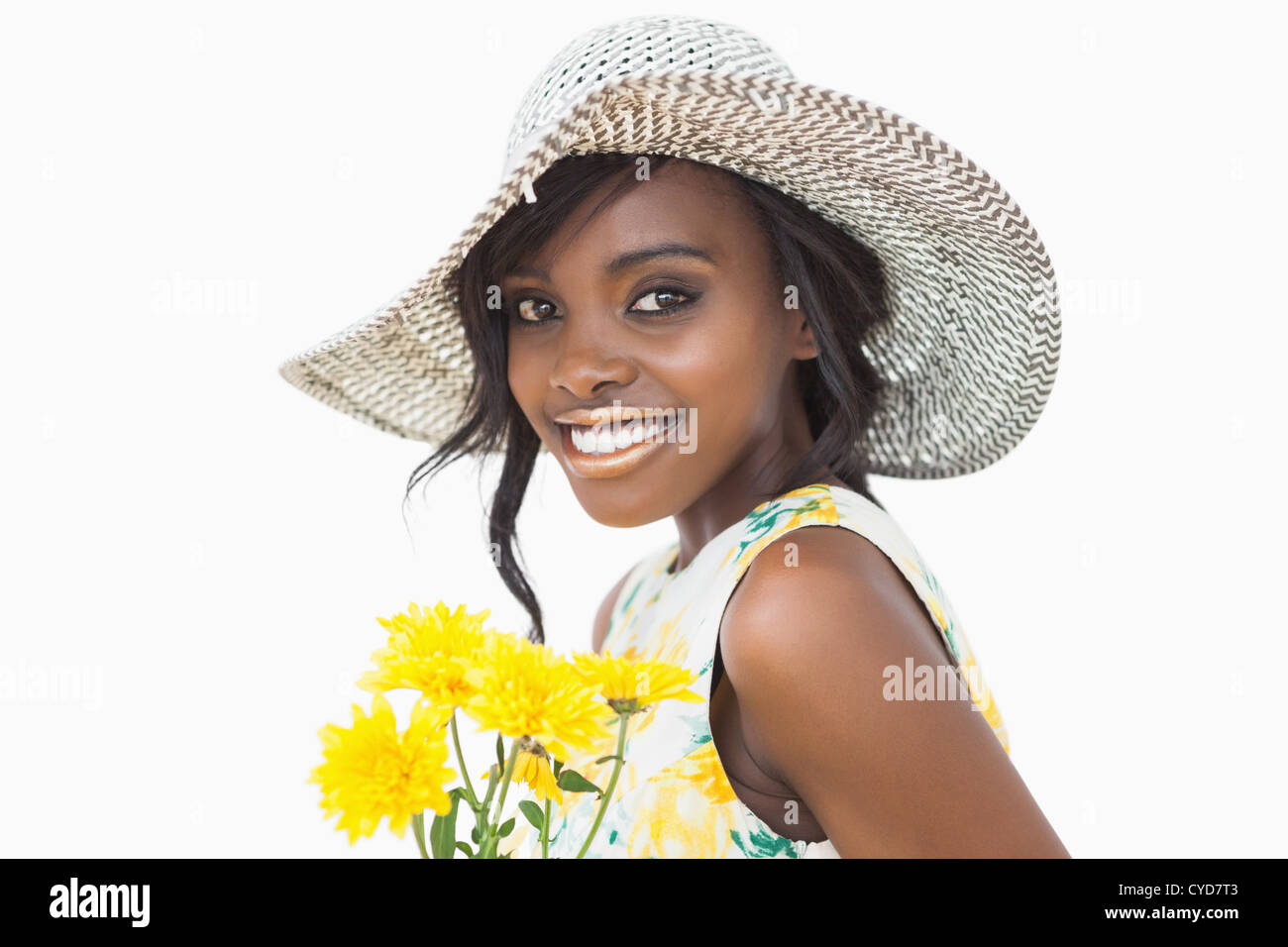 Woman standing while holding yellow flowers Stock Photo