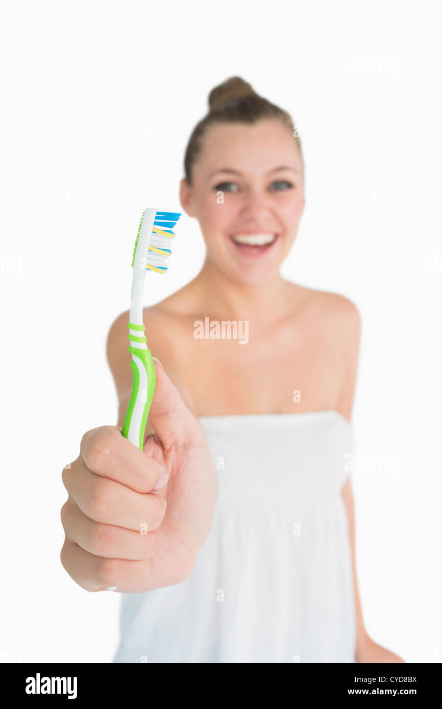 Happy woman showing a toothbrush Stock Photo