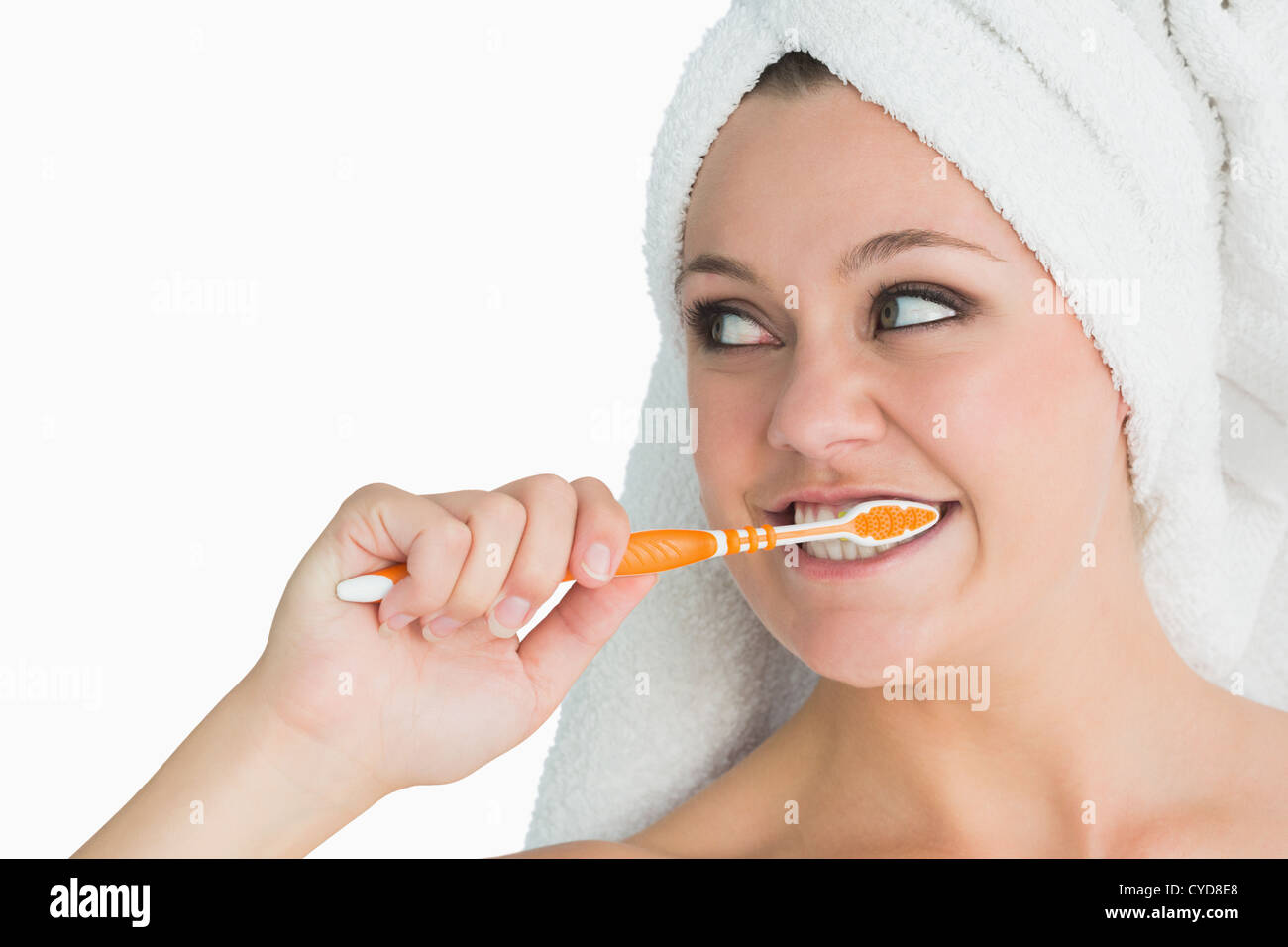 Woman with hair towel washing her teeth Stock Photo