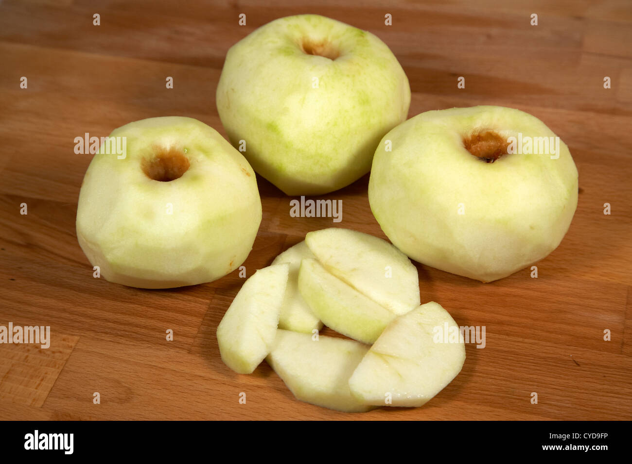 three peeled and one sliced bramley cooking apples Stock Photo Alamy