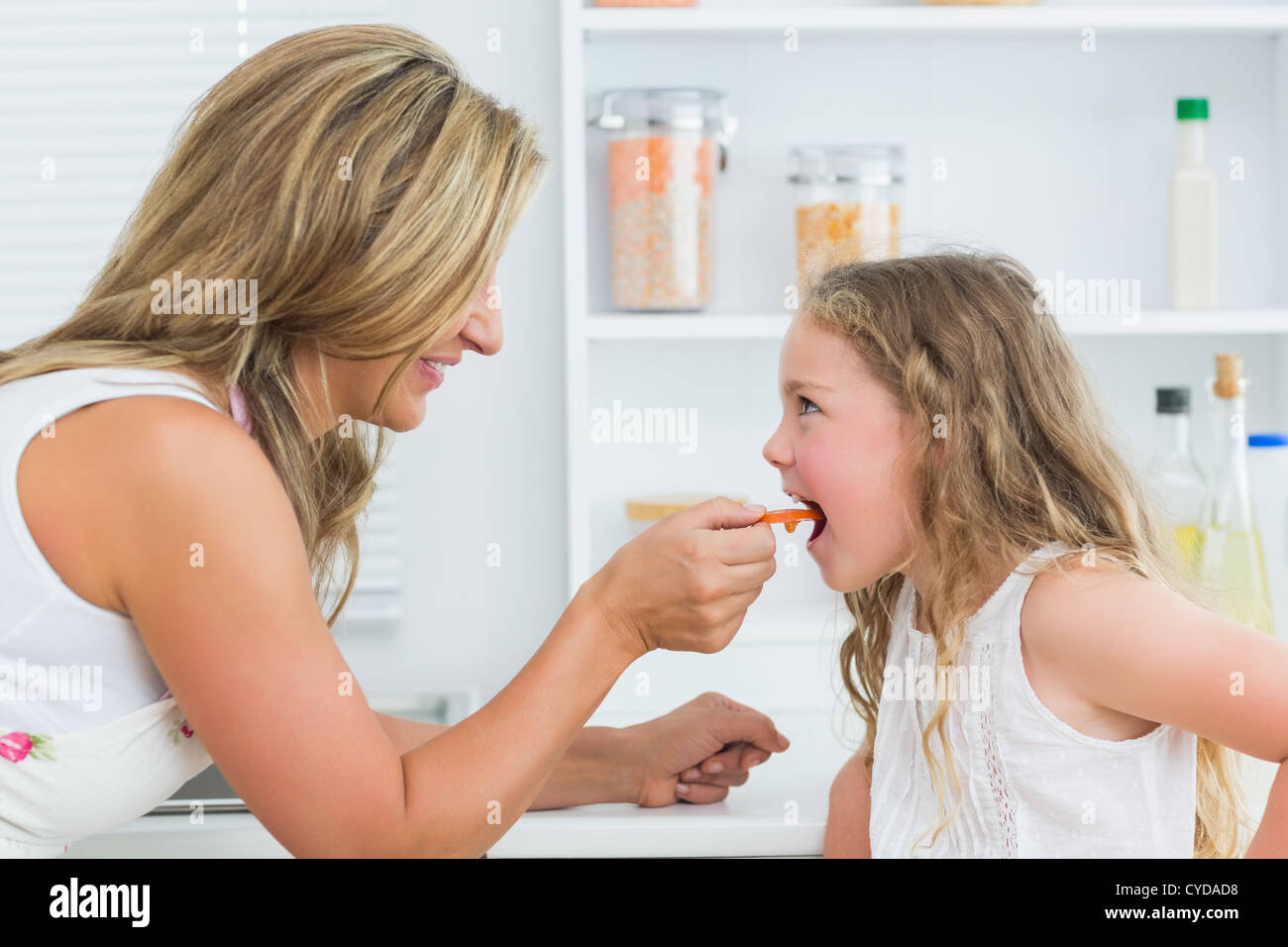 Mother feeding daughter Stock Photo