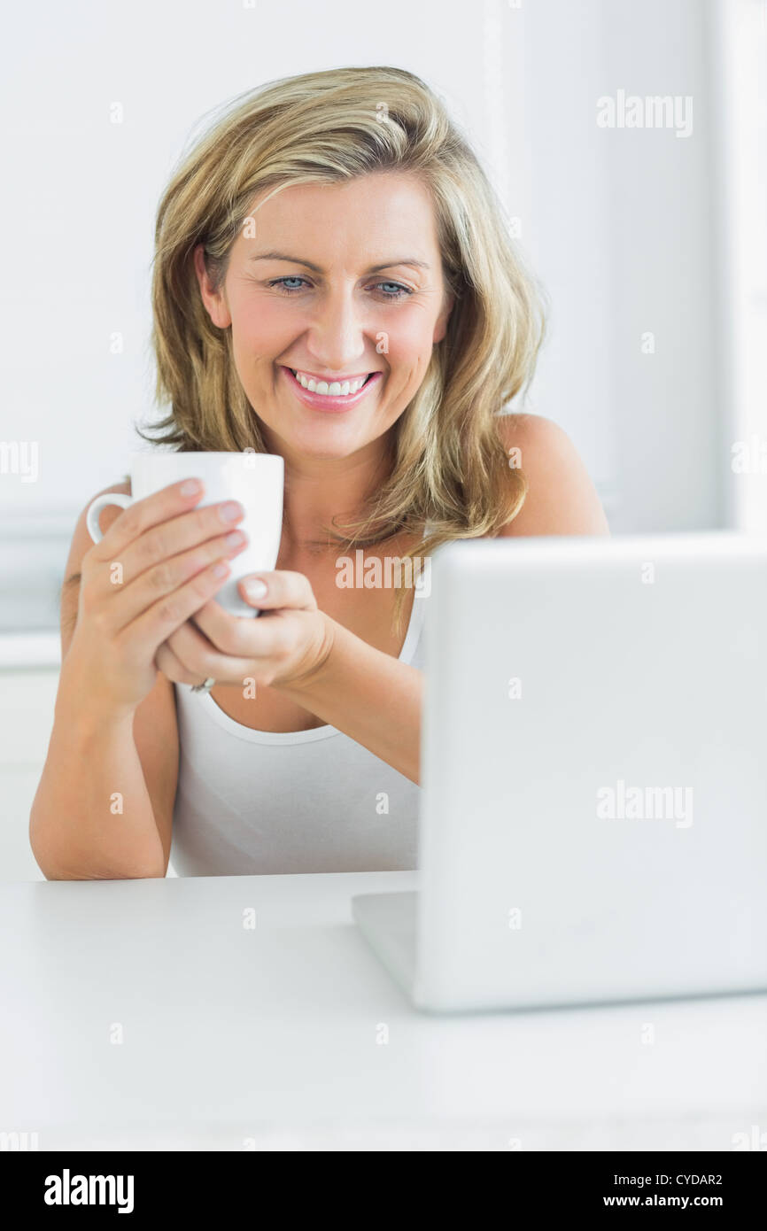 Smiling woman holding a mug Stock Photo