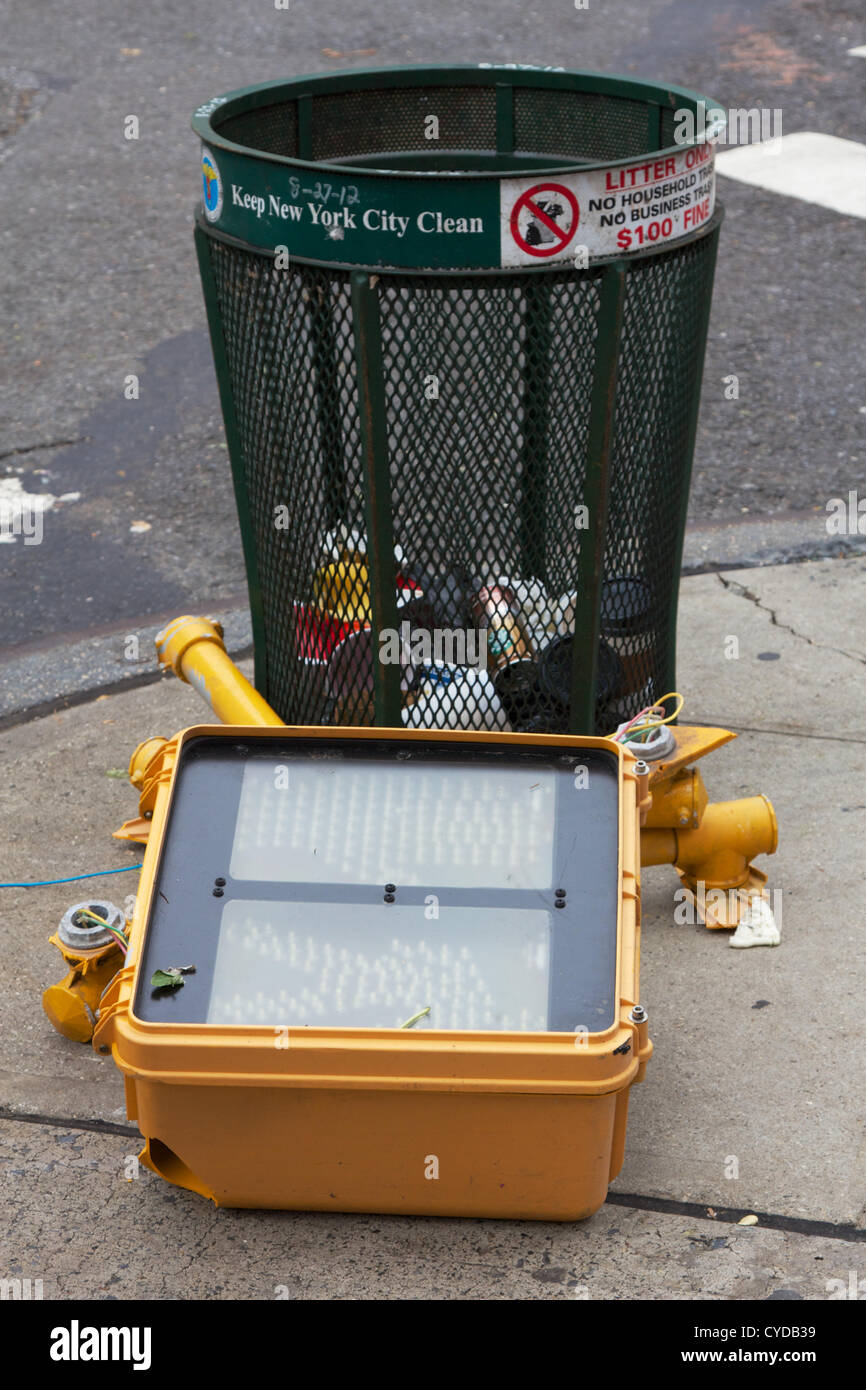 NEW YORK, NY - OCTOBER 31, 2012: Broken traffic light that fell during Hurricane Sandy lies discarded next to a trashcan in Lower Manhattan in New York, NY, on October 31, 2012. Stock Photo